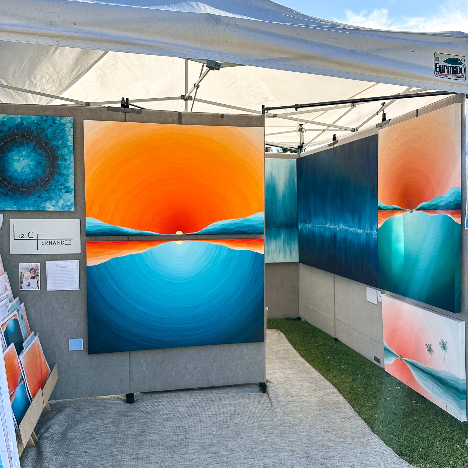 Original oil painting on canvas created by artist "Liz C Fernandez".  The painting is colorful, coastal with rich blue, teal, aqua, orange, red, peach, and gold.  Bright beachy sunset colors.